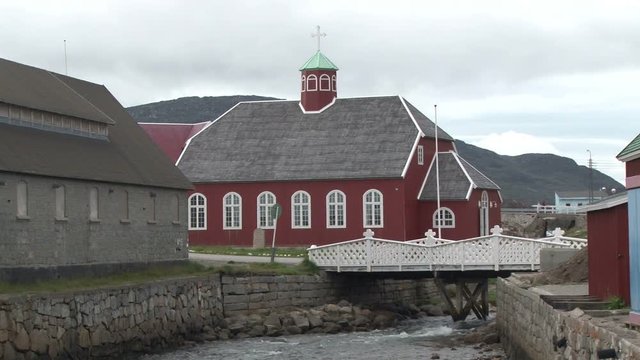 Fast running stream passing Saviours Church in Qaqortoq, Greenland