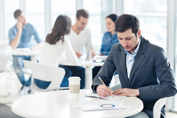 Pleasant man sitting at the table