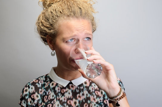 Young woman with glass of mineral water isolated