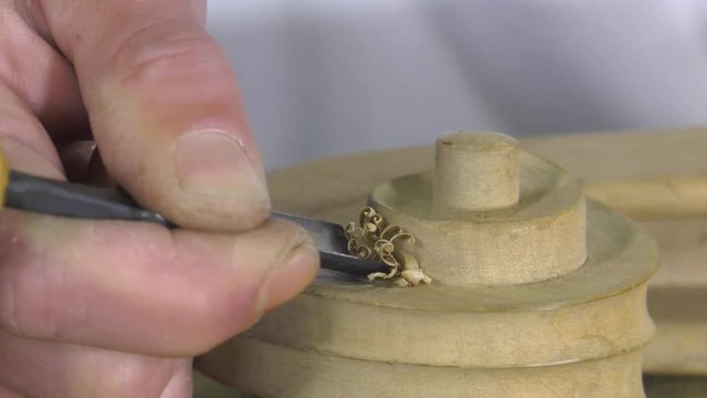 Luthier sculpt a cello head