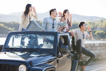 Friends having fun in a jeep