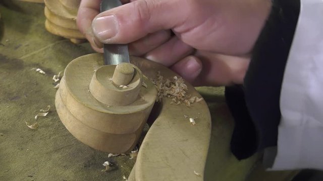 Luthier sculpt a cello head