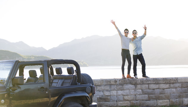Happy young men and jeep