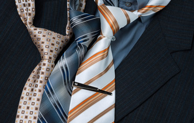 set of colorful men's ties isolated on dark background