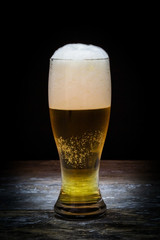 Beer mug on old wood background.