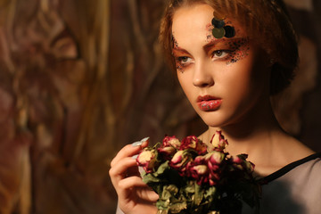 beautiful girl with dry roses