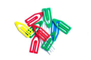 Multi-colored paper clips on a white background.