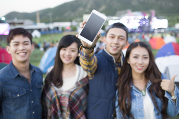 Happy friends showing a smart phone