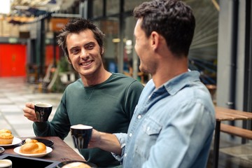 Obraz na płótnie Canvas Happy friends having coffee together