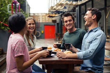 Happy friends having coffee together