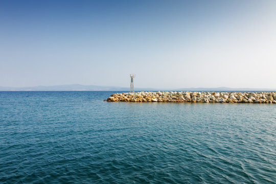 Sea pier on background of Mediterranean sea from Nea Fokia, Greece.