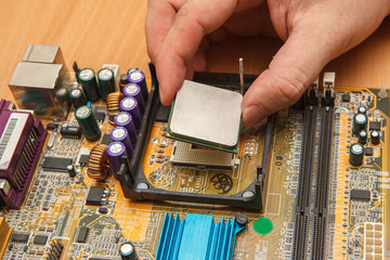 repairman inserted CPU into the socket on the motherboard. Close