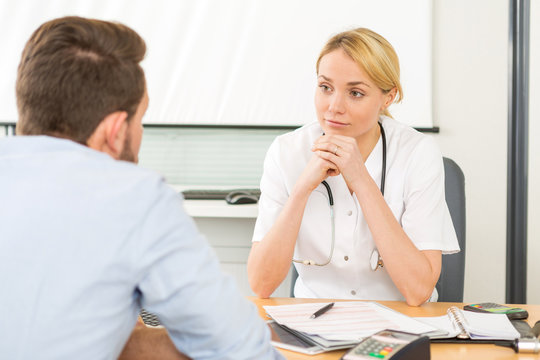 Young attractive woman doctor listening his patient