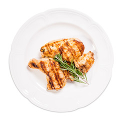 Grilled chicken fillet and legs with rosemary.