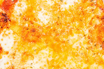 Obraz na płótnie Canvas Closeup of melted cheese on pizza.