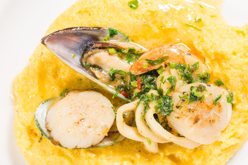 Delicious scallops and mussels with polenta.