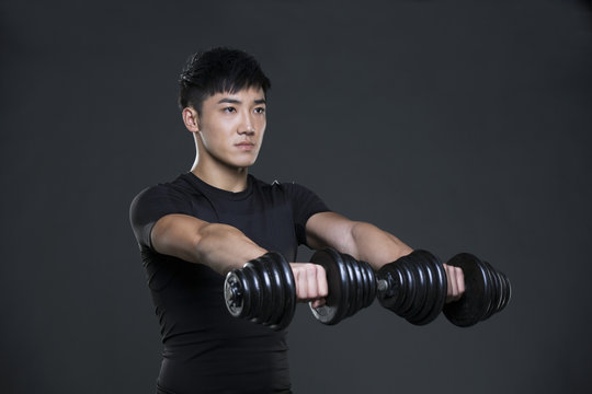 Young man lifting weights