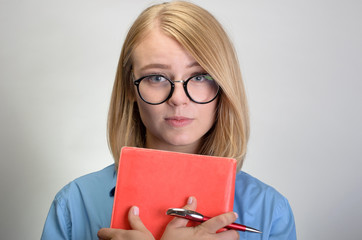 portrait of young woman with notebook and pen