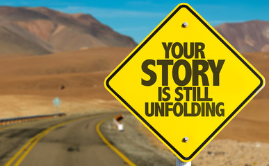 Your Story Is Still Unfolding sign on desert road