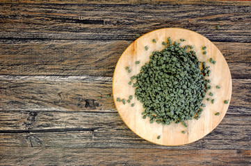 Ginseng Green Oolong Tea on wooden board on wooden background