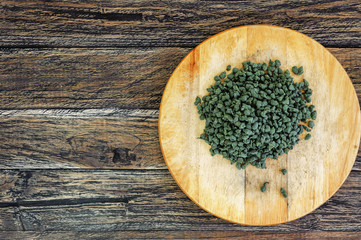 Ginseng Green Oolong Tea on wooden board on wooden background