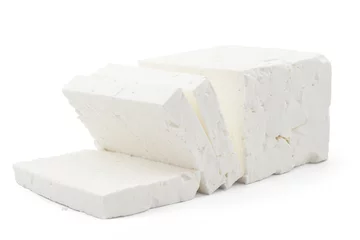 Poster Sliced fresh white cheese from cow's milk on white background © Simic Vojislav