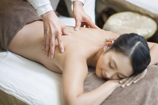 Young woman receiving shiatsu massage