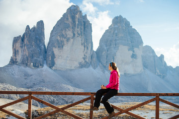 Girl tourist admires the peaks in the Alps