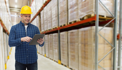 happy businessman with tablet pc at warehouse