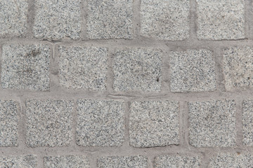close up of paving stone or facade tile texture