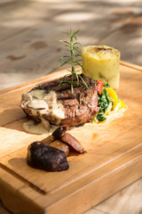 Grilled beefsteak with mushrooms and mixed vegetables.