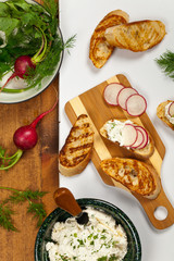 Bread Toasts with White Cheese and Radishes. Selective focus.