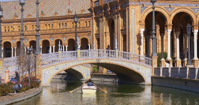 day light boat riding couple in plaza de espana fountain 4k seville spain

