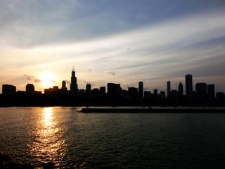 Fototapeta na wymiar Chicago skyline silhouette at dusk over water - landscape color photo