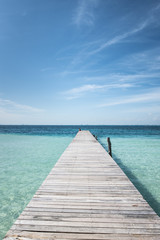 wooden dock into blue tropical sea in Isla Mujeres, Yucatan Mexico