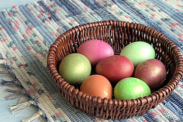  Easter eggs. Easter eggs in a wicker basket on a homespun rug.