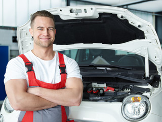Car mechanic is satisfied with his job 