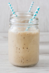 Banana smoothie on white table
