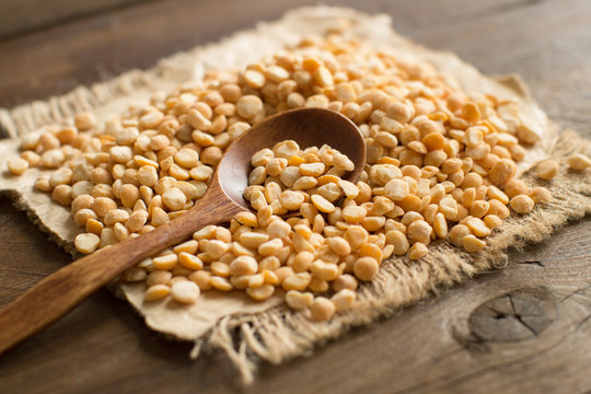 Pile of dried yellow peas with a spoon