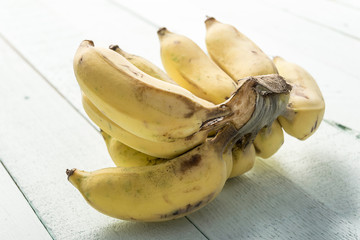 Bunch of dirty banana on wooden background