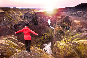 Tourist enjoying beautiful sunset over Markarfljotsgljufur canyon near by Emstrur / Botnar hut at Laugavegur trail, Iceland