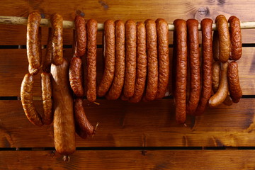 sausage on wooden background  - obrazy, fototapety, plakaty