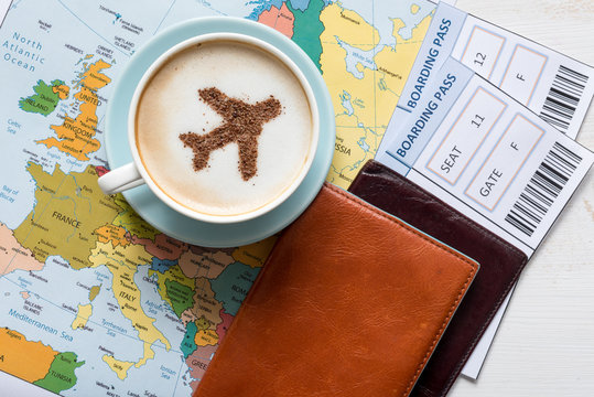 Aircraft made ofcinnamon in cappuccino, passports and boarding passes with Europe map. Travel concept