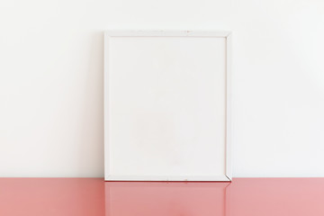 mockup of blank frame poster on wall