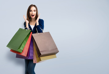 woman in casual clothing with shopping bags, with copyspace