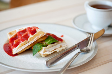 Belgian waffles with strawberry sauce