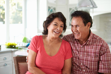 Head And Shoulders Shot Of Senior Hispanic Couple At Home