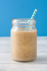 Banana smoothie on a wooden table
