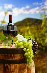 Fotobehang Red wine bottle and wine glass on wodden barrel. Beautiful Tusca © ZoomTeam