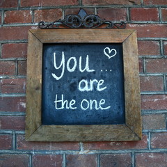 Fototapeta premium love/ saying about love written on a chalk board